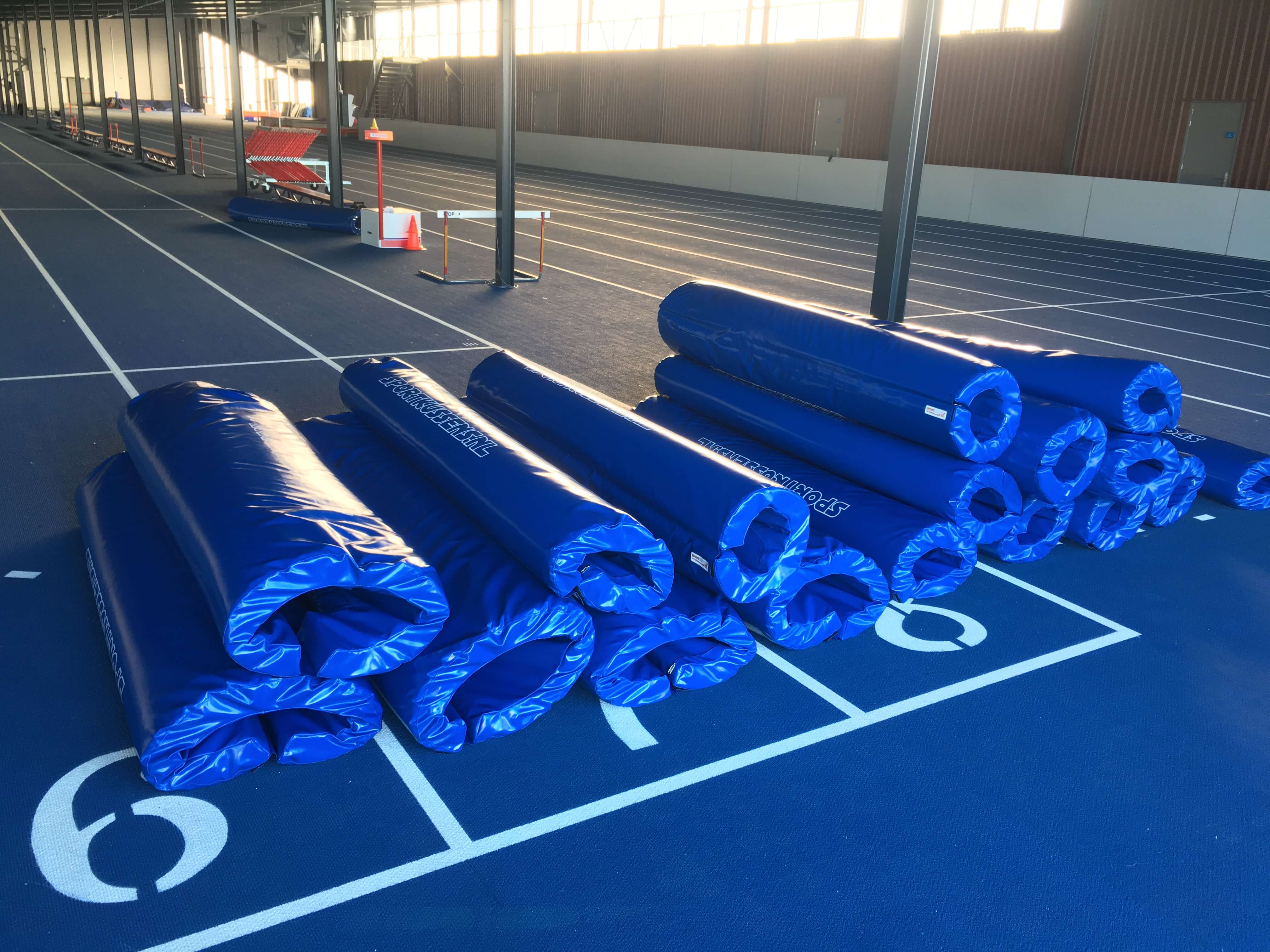 Ronde paalhoezen in blauw voor indoor atletiekbaan